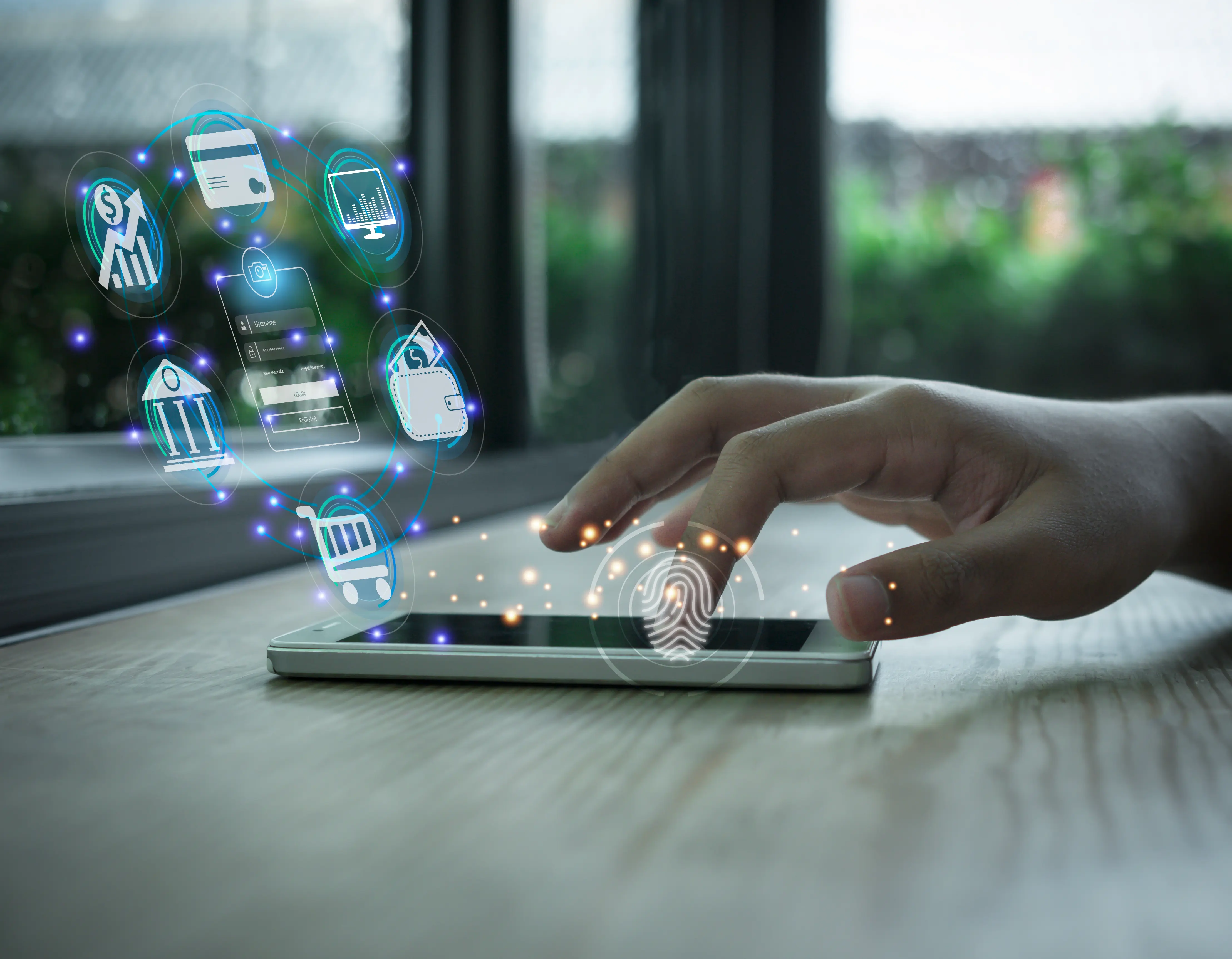 Hand interacting with a tablet displaying holographic financial and shopping icons.